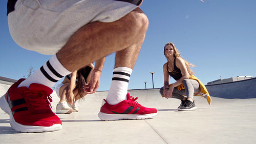 Happy friends taking pictures together in a skate park
