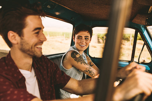 Young couple on a road trip driving in car