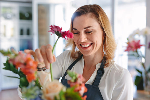Female florist arranging flowers in bouquet