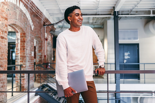 Smiling businessman standing in a modern office