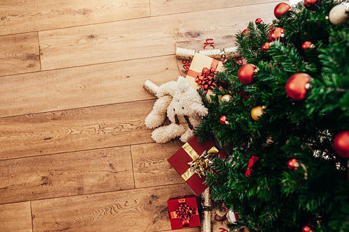 Gifts for Christmas placed beside a Christmas tree.