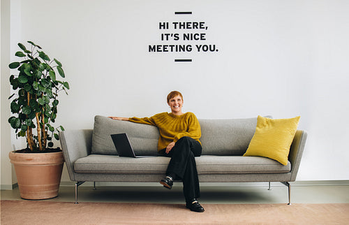 Businesswoman on sofa in office lobby