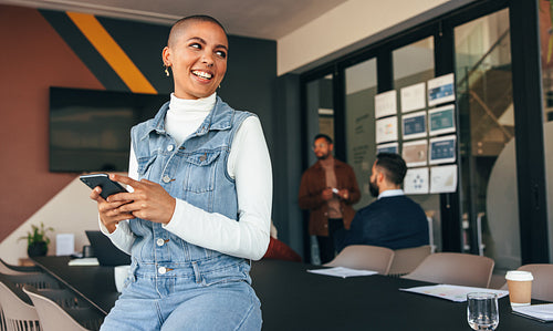 Excited businesswoman looking away thoughtfully