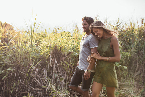 Romantic young couple walking together in countryside
