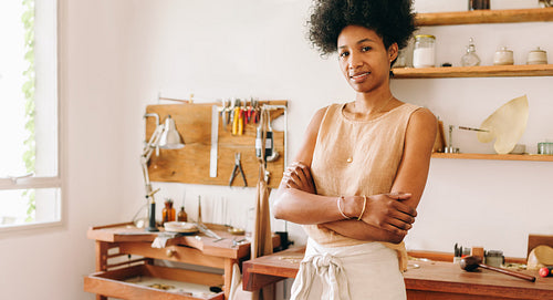 Confident owner standing in jewelry studio