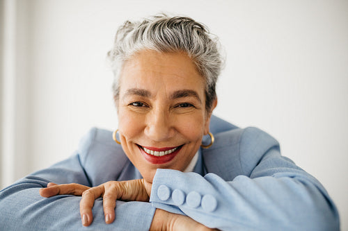 The face of success: Classy and experienced business woman smiling in her office