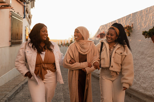 Best friends laughing while walking together