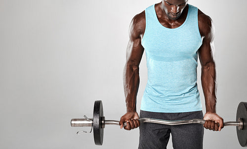 Male bodybuilder exercising with a barbell