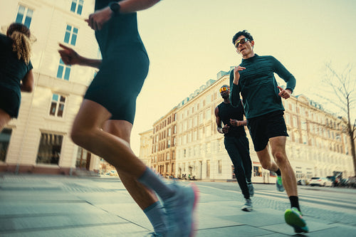 Motion drives the running group through city streets with urban fitness focus