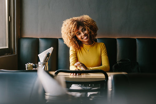 Cheerful woman sitting in a restaurant