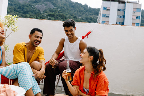 Friends enjoying a terrace gathering with snacks and beverages
