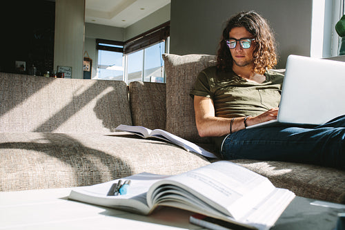 University student studying at home