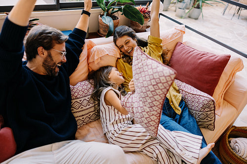 Family celebrates together on a cozy couch