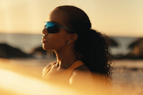 Championship beach volleyball match at sunset: Young woman athlete competing in coastal summer games