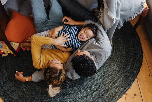 Overhead view of a little boy having fun with his mom and dad