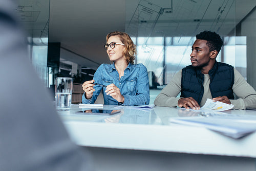 Female executive listening to her colleague during meeting