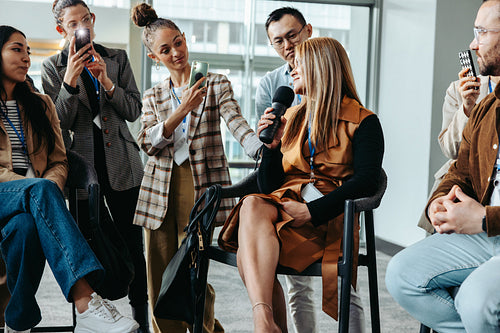 Famous presenter speaking at a conference while filming takes place