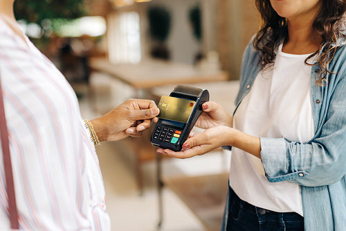 Store owner receiving a credit card payment from a customer
