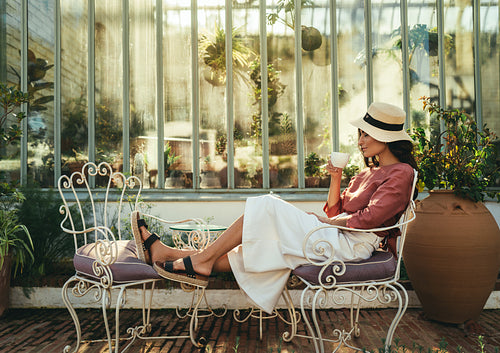 Tourist woman having coffee outside a hotel