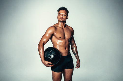 Fit young man with medicine ball 