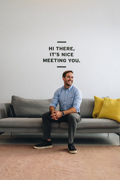 Positive male executive on sofa at lobby
