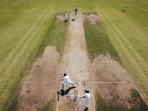 Aerial view of a cricket pitch during an active match