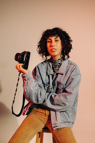 Confident young photographer holding a digital camera