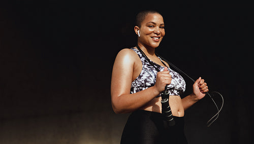 Healthy woman relaxing after skipping rope workout