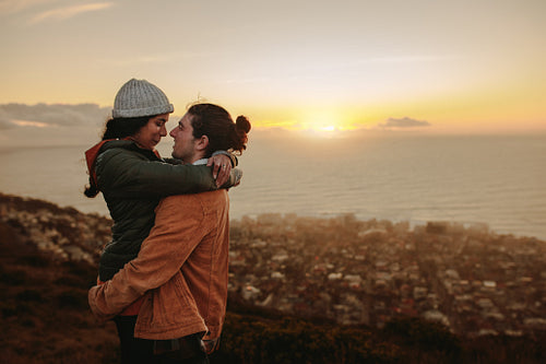 Loving couple at sunset in mountains