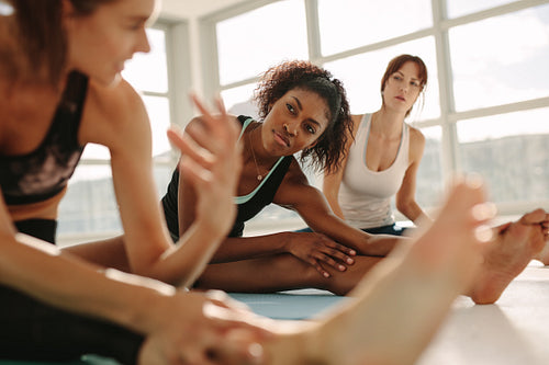 Women during yoga class break at gym