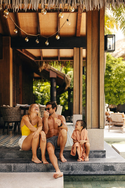 Happy young family enjoying vacation at tropical resort