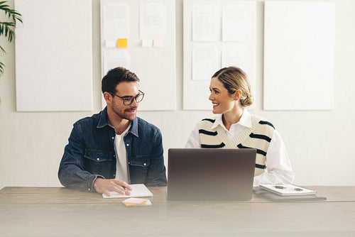Cheerful businesspeople having an online conference on a laptop