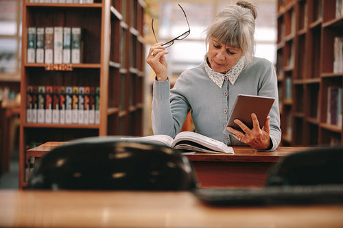 Woman reading a book in library