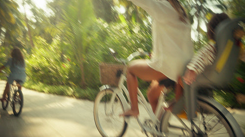 Mother and children cycling at a luxury island resort during their family vacation