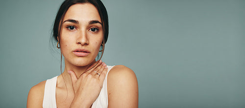Confident young woman embracing her skin in a studio