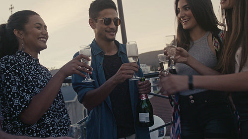 Group of friends celebrating with drinks at a rooftop party