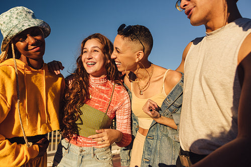 Carefree friends smiling while standing together