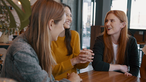 Group of young friends meeting in a cafe