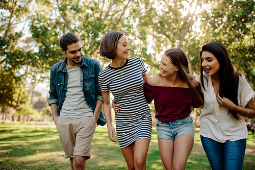 Cheerful friends walking in the park