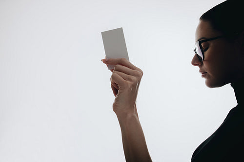 Professional woman holding blank business card for mockups and branding
