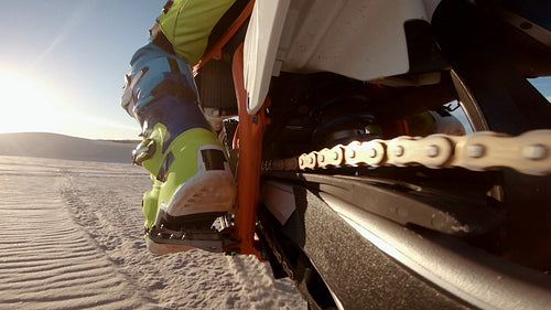 Low angle view of a motorcyclist riding a dirt bike in a desert