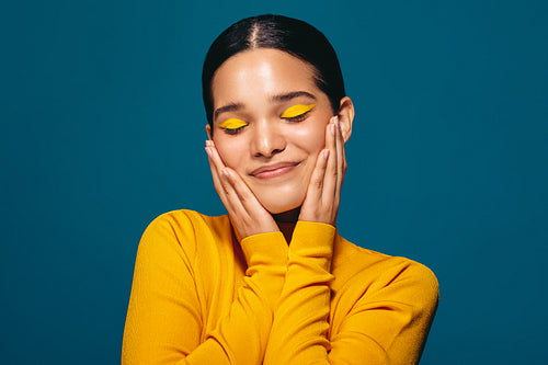 Empowered woman expressing her self love through makeup