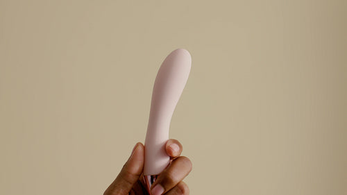 Intimate toy and lube on a neutral background