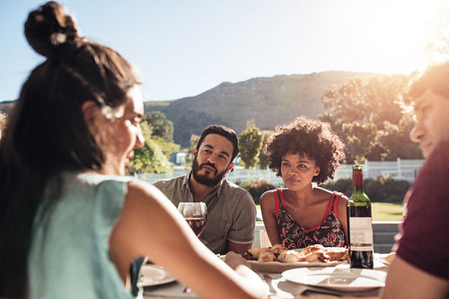 Group of young people having outdoor meal