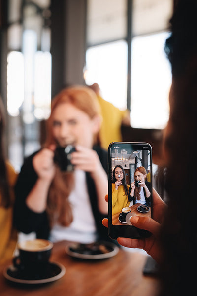 Woman taking funny pictures of friends