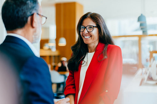 Professional discussion between two colleagues in a corporate environment