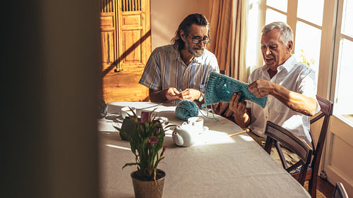 Retired seniors knitting at home
