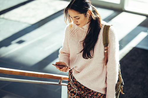 Female student in campus using mobile phone