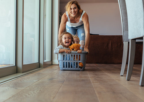 Children enjoying at home with mother