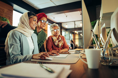 Happy businesswomen working together in a coworking office